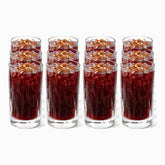 Set of 12 textured wavy glass tumblers 415ml filled with jallab, pine nuts and raisins