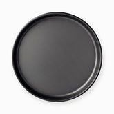 Top view of the graphite nonstick pizza pan showing the smooth flat base and rolled rim