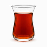 Single tulip-shaped clear glass Turkish tea glass filled with hot red tea