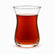 Single tulip-shaped clear glass Turkish tea glass filled with hot red tea