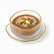 Ribbed glass dessert bowl with gold rim on ribbed gold-edged saucer filled with meghli