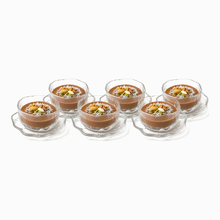 Set of 6 clear hammered glass dessert bowls with wavy saucers filled with meghli and nuts