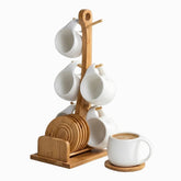 6 white ceramic cups on a bamboo mug tree with coaster holder, one cup of coffee on a coaster