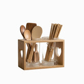 Wooden utensil holder with 2 glass drainer cups holding wooden spoons and chopsticks